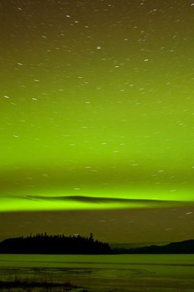 There are strange things done ' neath the midnight sun. This is a photo of the northern lights, at the edge of Lake Laberge.